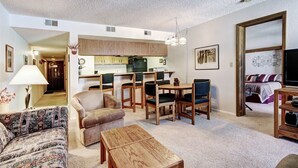 A compact living space with a dining area, kitchen, and a bedroom with a TV. - 2 bedrooms, 6 blocks from Main Street, Frisco! Bike path right outside! (Frisco)