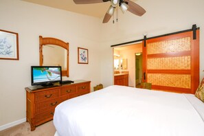 A hotel room with a bed, a television, a dresser, a mirror, and a sliding door. - Napili Point | Oceanfront 2 BR | Water Front | Car Incl. w/ 6+ Nights | NAP-C18 by KBM (Lahaina)
