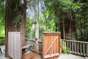 A wooden deck with a wooden gate and a wooden bench.