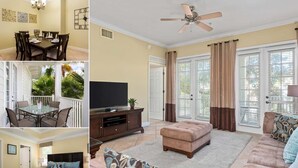 A living room with a ceiling fan, a television, a sofa, and a dining area with a table and chairs. - Beautifully Furnished Luxury Condo! Amazing Value near Disney (Kissimmee)