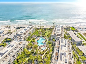 A hotel with a rooftop pool, beach access, and a view of the ocean.