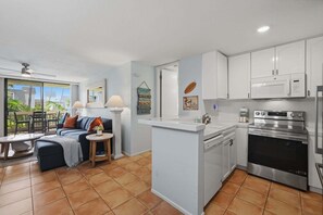 A modern kitchen with white cabinets, a built-in oven, and a microwave. - Beach Theme Condo with Ocean & Pool View G222 North Coast Village (Oceanside)