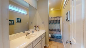 A bathroom with a sink, mirror, and toilet.