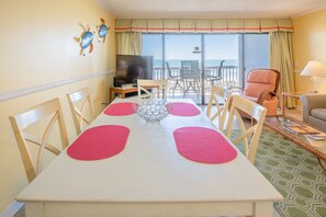 Enjoy meals in the dining area with a table for four and a TV for entertainment.