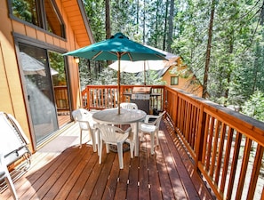 Enjoy meals and relaxation on the deck with a round table and comfortable seating for four.
