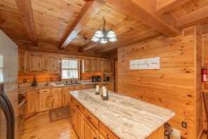 Enjoy cooking in this well-equipped kitchen with a central island, cabinetry, and a countertop.