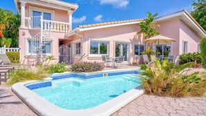 A two-story house with a swimming pool, outdoor furniture, and a garden. - P34 - Beautiful 4 bedroom 2 bath, single family home with private pool and deep water dockage. (Key Colony Beach)