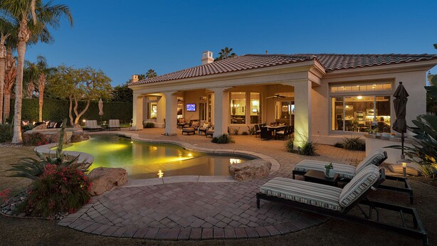 A house with a swimming pool, outdoor seating, and a well-lit patio area. - FALL FLASH SALE -Luxe Pool, Misters Firepit Lounge & Billiards (La Quinta)