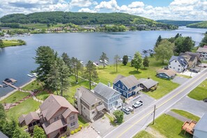 A residential area with houses, a road, and a lake.