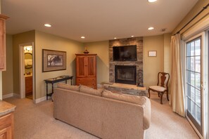 Flat-screen TV, fireplace, DVD player, computer monitors