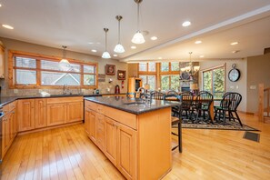 Enjoy cooking in this well-equipped kitchen with a large island, sink, and ample counter space.