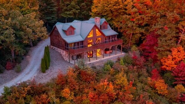 A large, rustic cabin with a prominent chimney, surrounded by dense forest. - Theater Room,Pool Table,Foosball,HotTub,WiFi,Views (Ferguson)