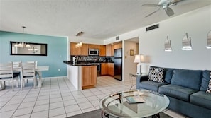 A modern apartment with a kitchen, dining area, and living room. - Coquina Beach Club 202 - Anna Maria Island- Condo 2 Bedroom/ 2 Bath ocean view, maximum occupancy of 6 people. (Bradenton Beach)