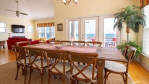 A spacious living room with a dining area, a television, and a view of the ocean. - Sandstep 616-2 (Carolina Beach)