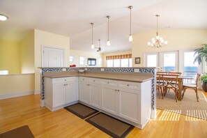 Enjoy cooking in this well-lit kitchen with a dishwasher and large island with a sink.