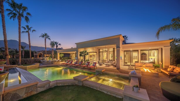 A modern resort with a swimming pool, sun loungers, and a well-lit outdoor seating area. - FALL GETAWAYS 25% OFF Poolside Perfection 50ft Pool Dreamy Vibes (LA QUINTA)