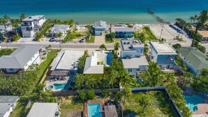 A coastal residential area with houses, a beach, and a pier. - A Time Out: *Quaint Cottage *Heated Pool *Across the street from the Bay! (Anna Maria)
