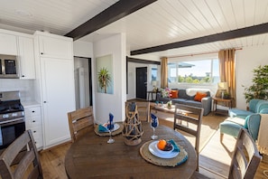 Relax in this open-plan living space with a kitchen, dining area, and comfortable seating.