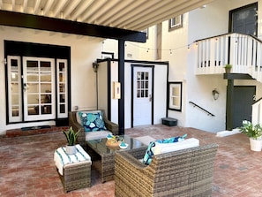 Relax in this inviting outdoor seating area with a sofa, armchairs, and a coffee table.
