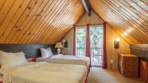 A bedroom with two beds, wooden ceiling, a nightstand, a lamp, and a window with curtains. - Chalet #25, Charming Ski in/ Ski Out, just steps to the Mountain (Mammoth Lakes)