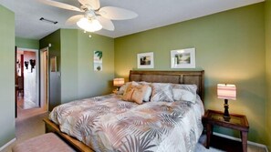 A bedroom with a large bed, a ceiling fan, and two bedside lamps. - Pelican Cove 4 - Anna Maria Island - Condo 2 Bedroom /2 Bath beach side, maximum occupancy of 5 people. (Bradenton Beach)