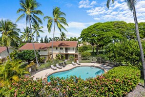 A resort with a swimming pool, palm trees, and a two-story building with a red roof. - LAST MINUTE DISCOUNT SPECIAL!  New Ductless Split A/C System! (Kailua-Kona)