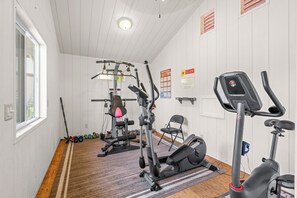 A gym with exercise equipment, a standing bike, and a mat. - LAST MINUTE DISCOUNT SPECIAL!  New Ductless Split A/C System! (Kailua-Kona)