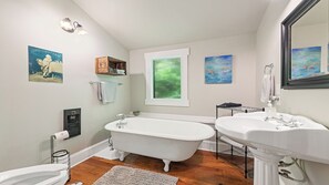 Bathtub, hair dryer, towels, toilet paper