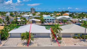 A coastal residential area with houses, a clear sky, and a view of the ocean. - P22 - Lovely 3 bedroom 2 bath duplex with private pool, dockage and Cabana Club (Key Colony Beach)