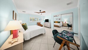 A hotel room with a bed, a desk, a chair, a television, and a ceiling fan. - P22 - Lovely 3 bedroom 2 bath duplex with private pool, dockage and Cabana Club (Key Colony Beach)