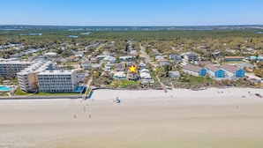 A coastal town with a beach, residential buildings, and a large hotel with multiple floors and balconies. - 🏖️LaKaSa House on Hill Street-Oceanfront Home with Gorgeous Views🏖️ (New Smyrna Beach)