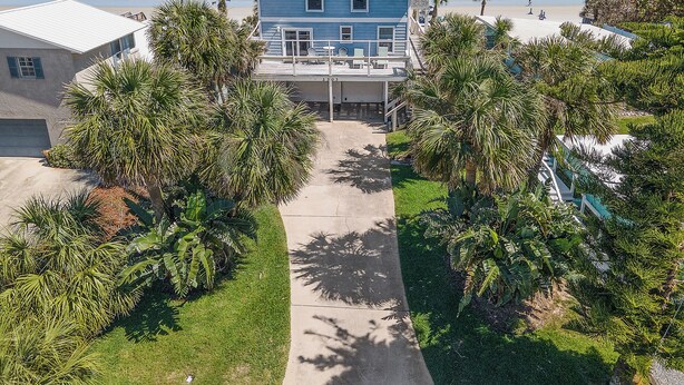A beachfront property with a pathway leading to a house, surrounded by palm trees and a view of the ocean. - 🏖️LaKaSa House on Hill Street-Oceanfront Home with Gorgeous Views🏖️ (New Smyrna Beach)