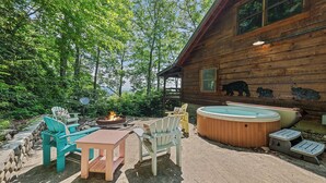 A wooden cabin with a hot tub, outdoor seating, and a fire pit. - Log Cabin right next to entrance of the Great Smokey Mountains National Park! (Waynesville)