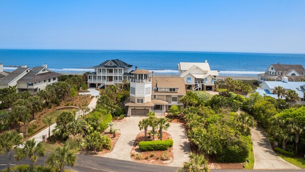 A coastal residential area with multiple houses, a clear view of the ocean, and well-maintained landscaping. - Huge Oceanfront Home with Full Golf Membership (Georgetown)