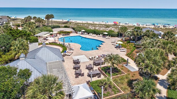 A resort with a swimming pool, beach, and palm trees. - Inviting Beach Retreat with wonderful Lake Views to Relax and Enjoy (Georgetown)
