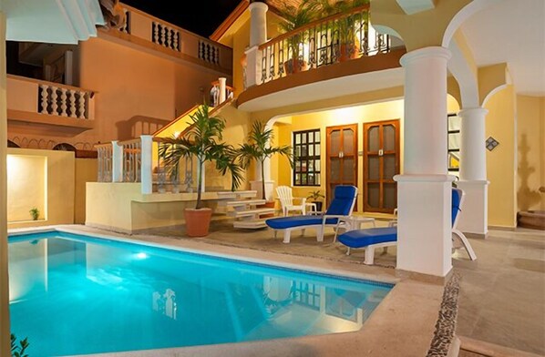 Relax by the pool surrounded by balconies and lush greenery.