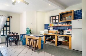 Enjoy cooking in this well-equipped kitchen with a central island and stools for seating.