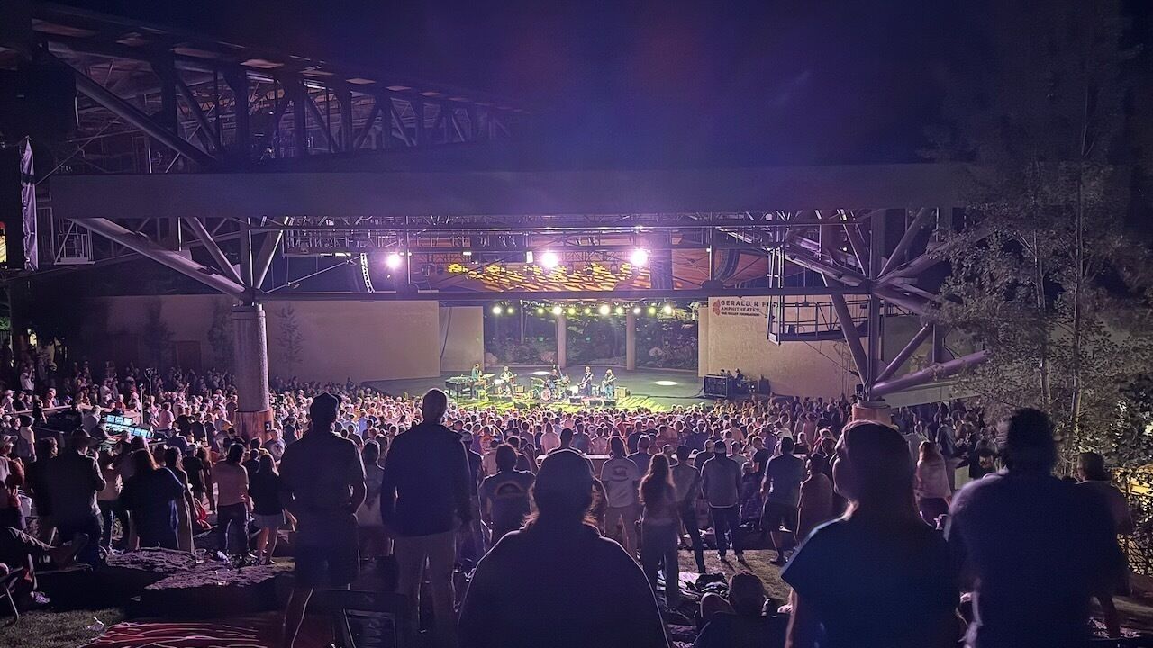 A large outdoor venue with a stage and audience.