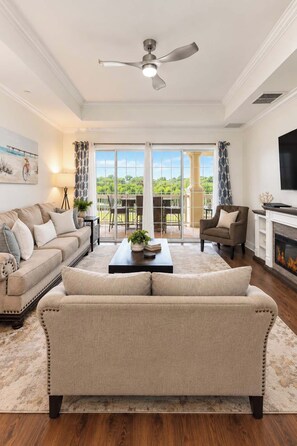 A living room with a sofa, coffee table, and a fireplace.
