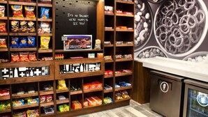 A snack display with various brands and a chalkboard sign. - Hampton Inn Lebanon (Lebanon)