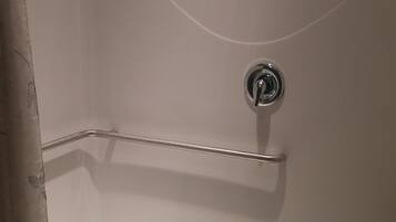 A white bathtub with a chrome faucet and a blue drain.