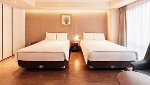 A hotel room with two single beds, a nightstand, a lamp, a framed picture on the wall, and a window with curtains. - Hotel Thomas Myeongdong (Seoul)