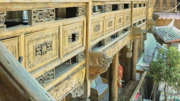 A traditional wooden building with intricate carvings and multiple balconies. - Lijiang Shanju Zuihuayin Inn (Lijiang)