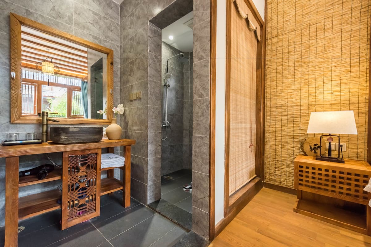 deluxe room | bathroom | shower, free toiletries, hair dryer, slippers