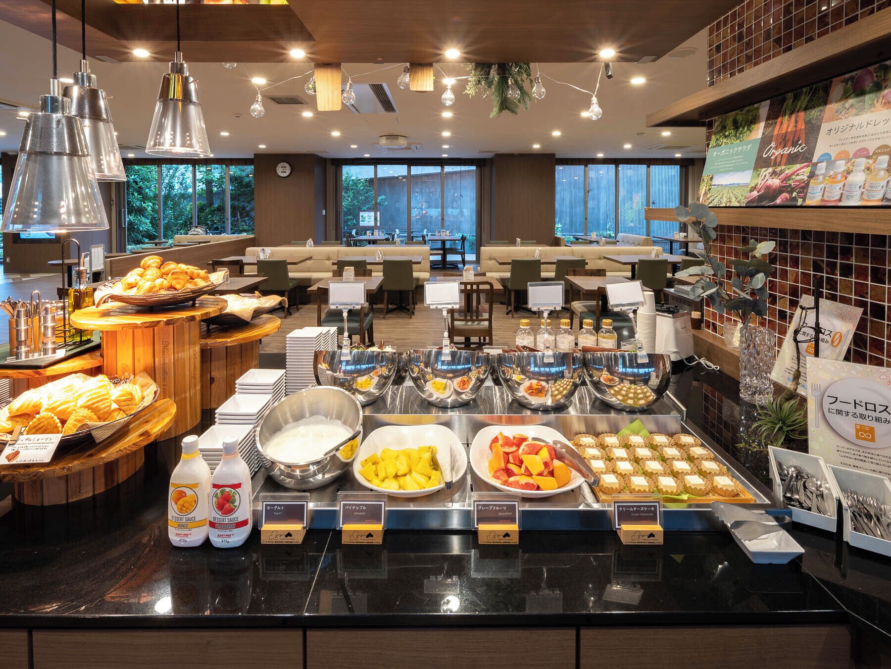 A buffet area with various food items and sauces, including a selection of pastries, fruits, and desserts.