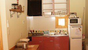 A compact kitchen with a refrigerator, microwave, and a small sink. - La Posada (Fujikawaguchiko)