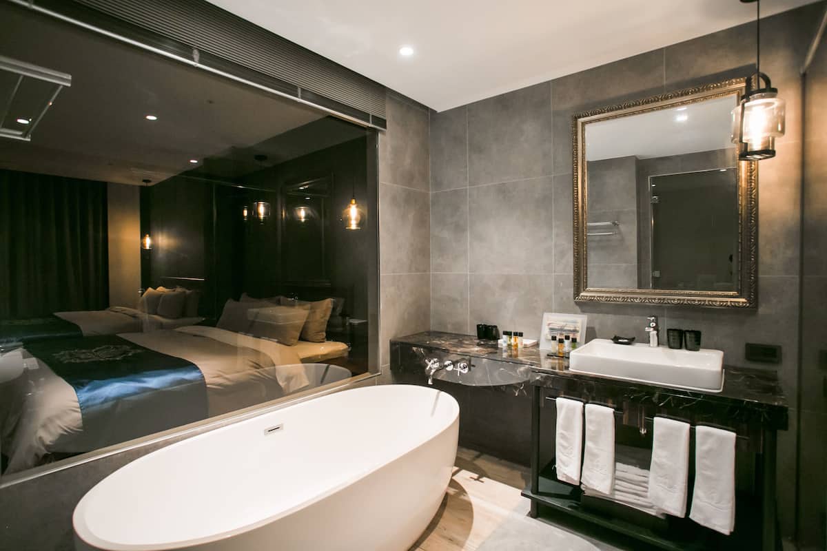 separate bathtub and shower, hair dryer, slippers, towels