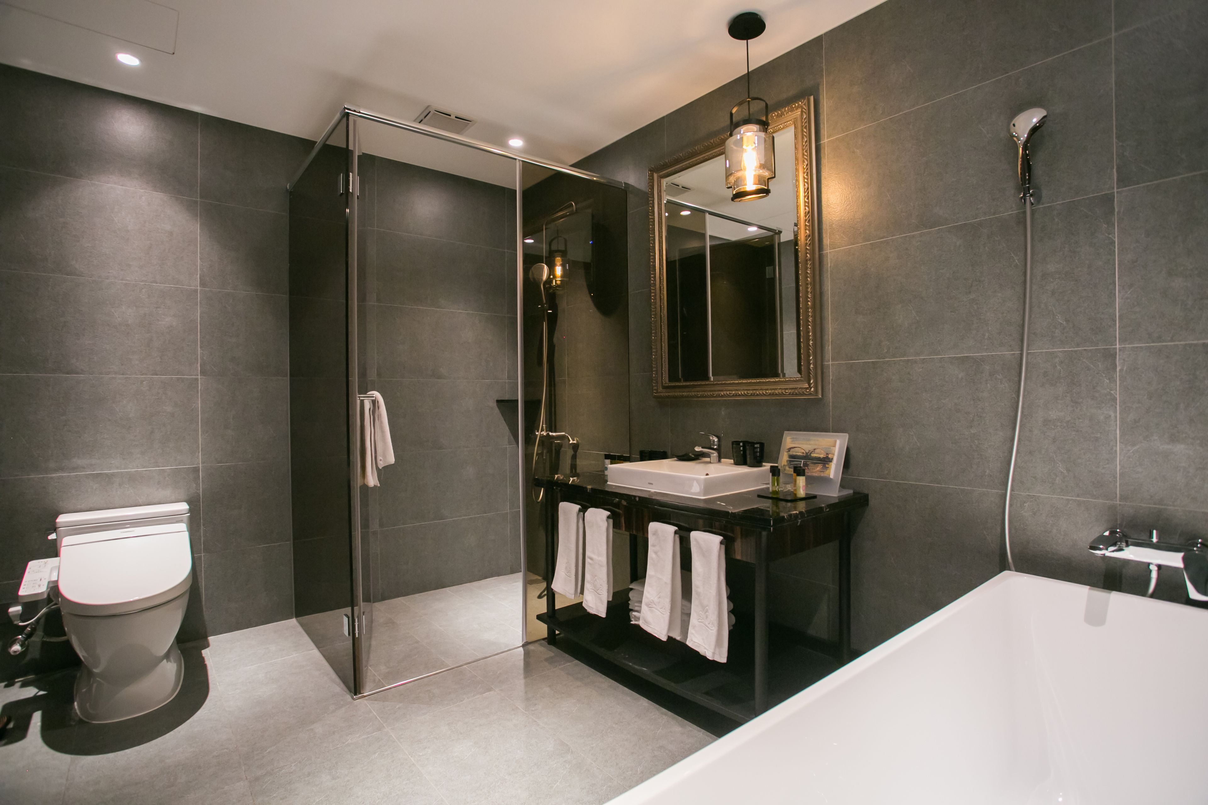 separate bathtub and shower, hair dryer, slippers, towels