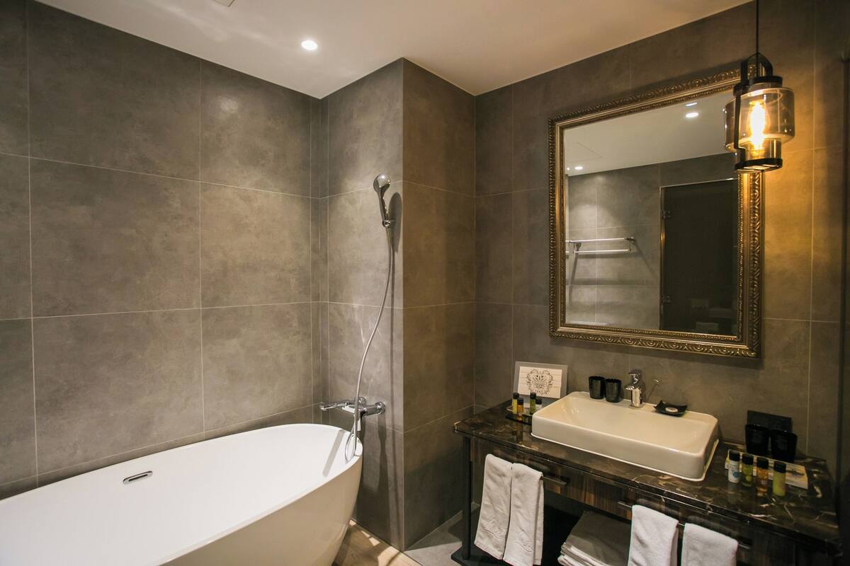standard quadruple room | bathroom | separate bathtub and shower, hair dryer, slippers, towels
