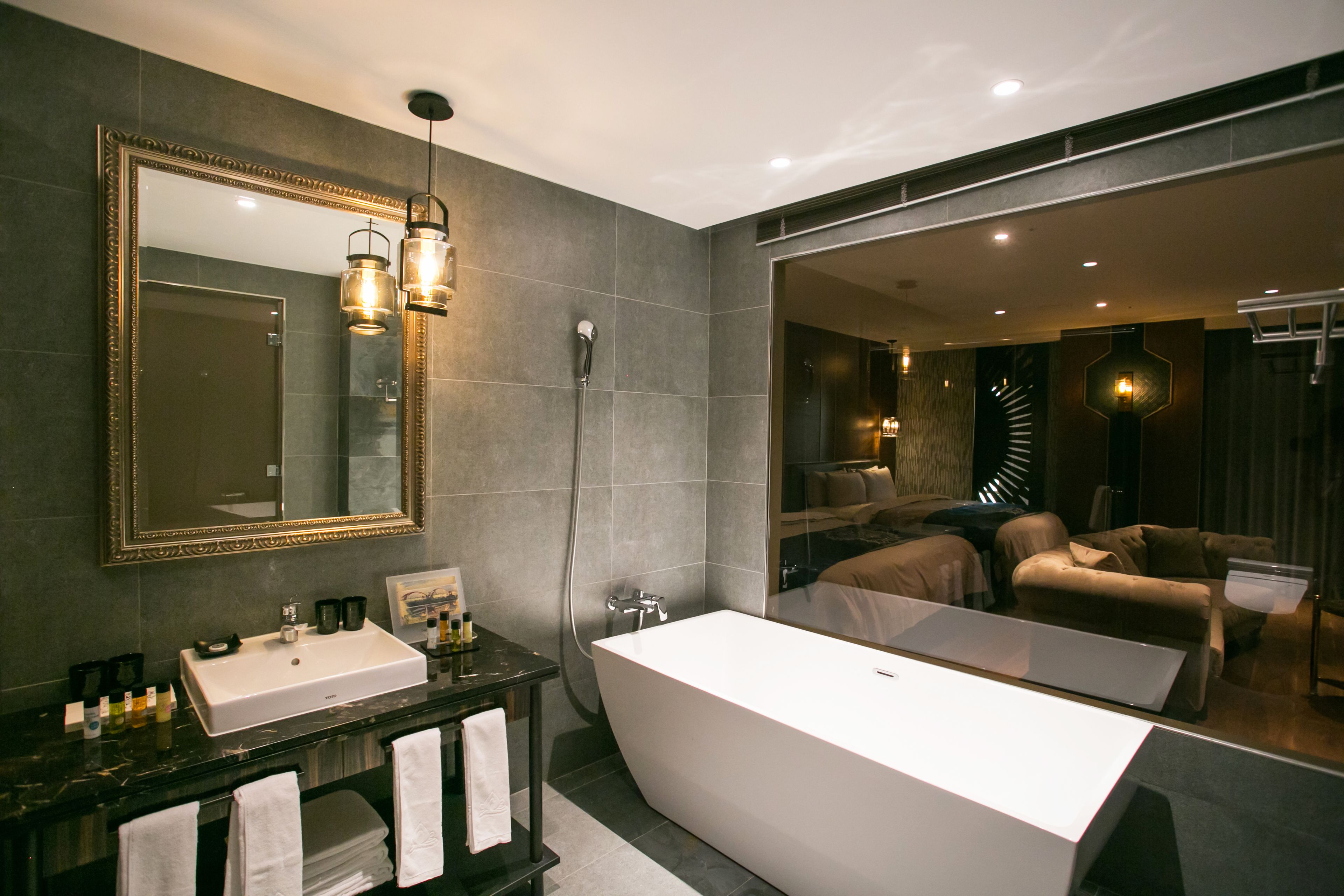 deluxe quadruple room | bathroom | separate bathtub and shower, hair dryer, slippers, towels